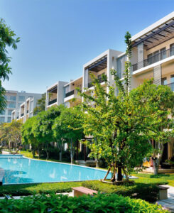 Luxurious SKHAI residences with a serene pool and lush landscaping