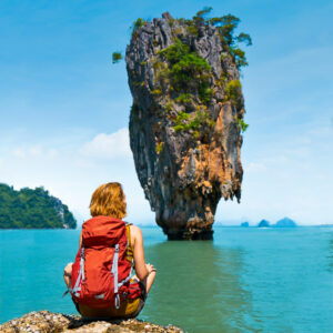 A traveler gazes at a stunning rock formation in Phang Nga Bay, Thailand.