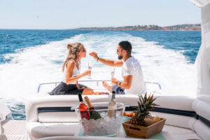 Couple enjoying champagne on a luxury yacht, SKHAI luxury real estate