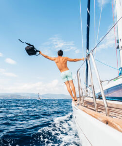 Man enjoying sailing on a luxury yacht at sea