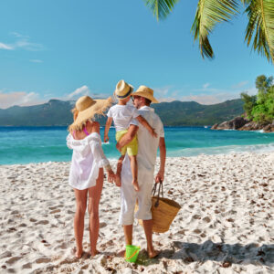 Family enjoying a beach day near SKHAI luxury real estate properties