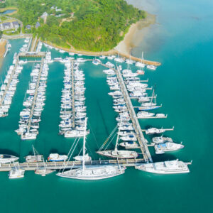 Aerial view of a luxury marina with yachts at SKHAI luxury real estate.