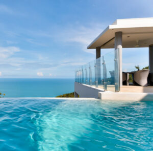 Infinity pool overlooking the ocean at a SKHAI luxury real estate property