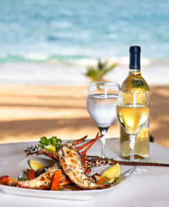 Gourmet seafood dish with wine by the beach, SKHAI luxury real estate