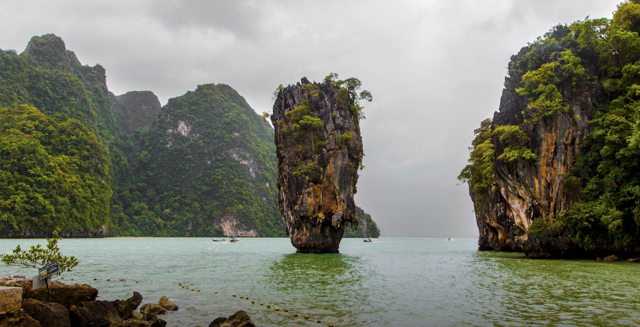 Dramatic limestone cliffs rising from tranquil waters for Home > Destinations slider