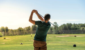 Golfer practicing swing near Sunrise Lake Phuket